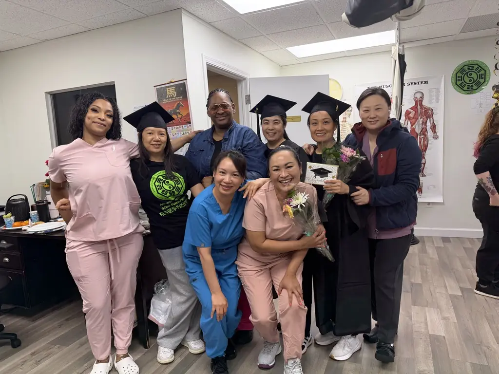 AMOM graduates and school community gathered together in the classroom